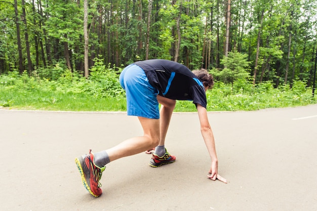 Young fitness man ready to start running.