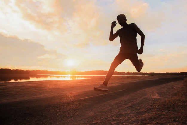 Young fitness man runner athlete running at road for exercise.