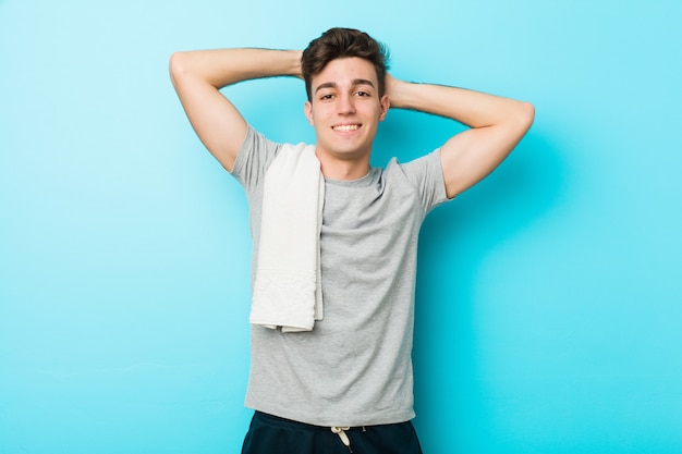 Young fitness teenager man stretching arms