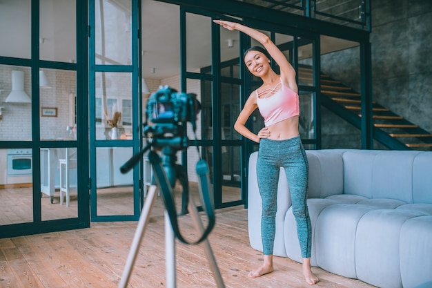 Young fitness vlogger recording a video