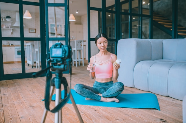 Young fitness vlogger recording a video