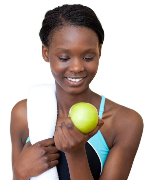 Young fitness woman eating an apple 