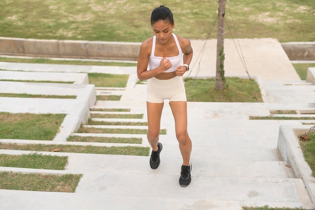 A young fitness woman in sportswear exercising in city park Healthy and Lifestyles