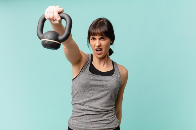 young fitness woman with a dumbbell