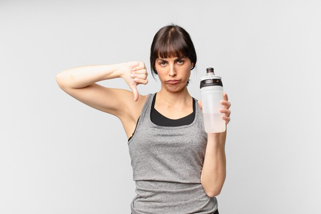 Young fitness woman with a water can