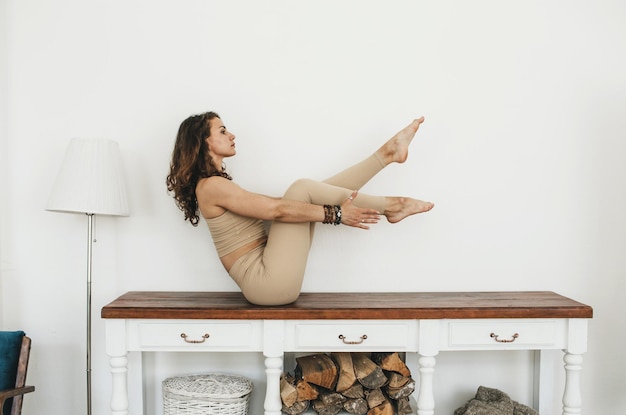 Young flexible girl does yoga and gymnastics, yoga and fitness