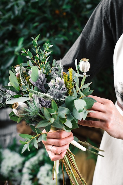 Young florist woman making beauty bouquet