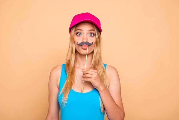 Young foolish girl holding fake mustache s