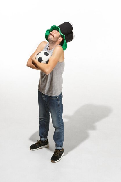 Photo the young football fan - man hugging soccer ball isolated on a white background