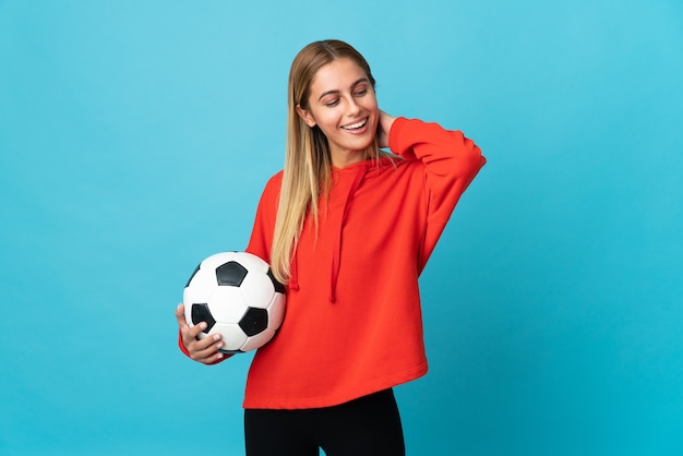 Young football player woman isolated laughing