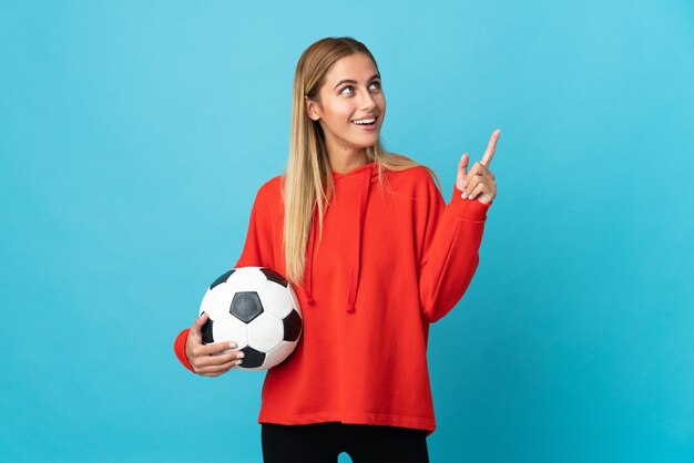 Young football player woman isolated pointing up a great idea