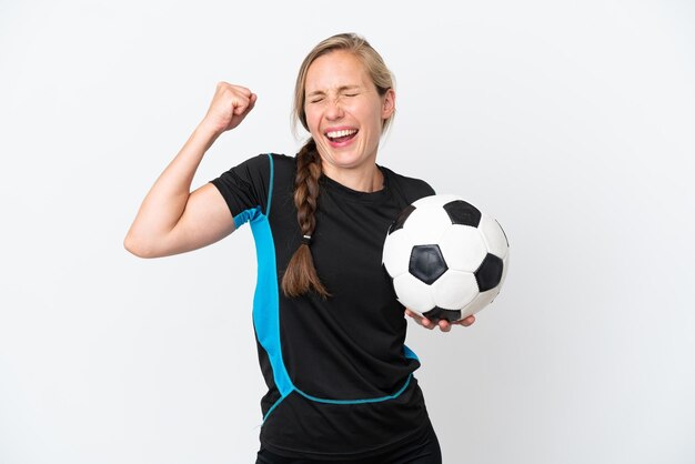 Young football player woman isolated on white background celebrating a victory