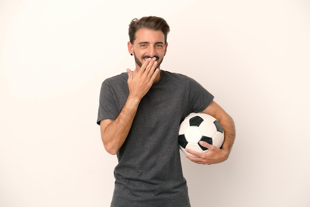 Young football player woman isolated on white background happy and smiling covering mouth with hand