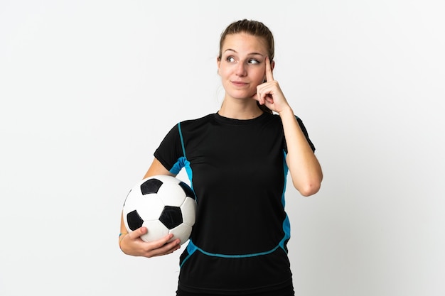 Young football player woman isolated on white background having doubts and thinking