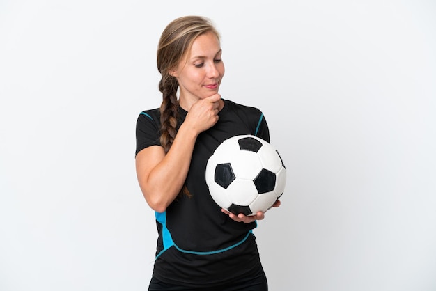 Young football player woman isolated on white background looking to the side and smiling