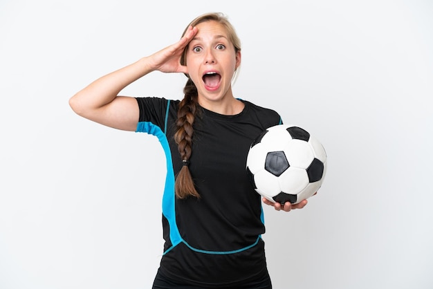 Young football player woman isolated on white background with surprise expression