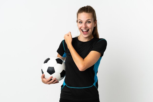 Young football player woman isolated on white celebrating a victory