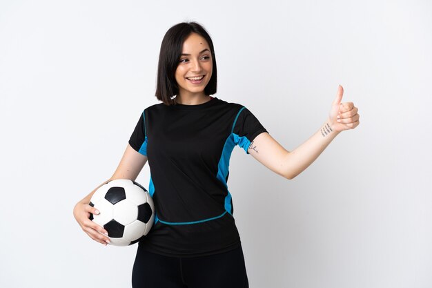 Young football player woman isolated on white giving a thumbs up gesture