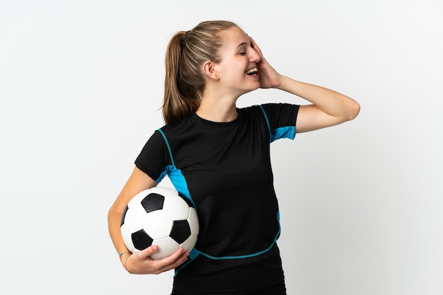 Young football player woman isolated on white wall smiling a\
lot