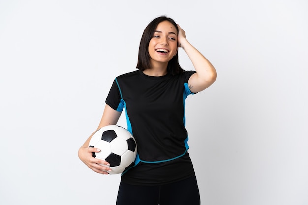 Young football player woman isolated on white wall smiling a lot