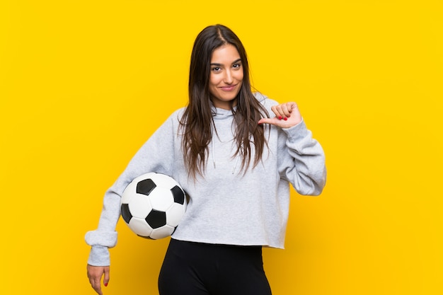 Young football player woman proud and self-satisfied