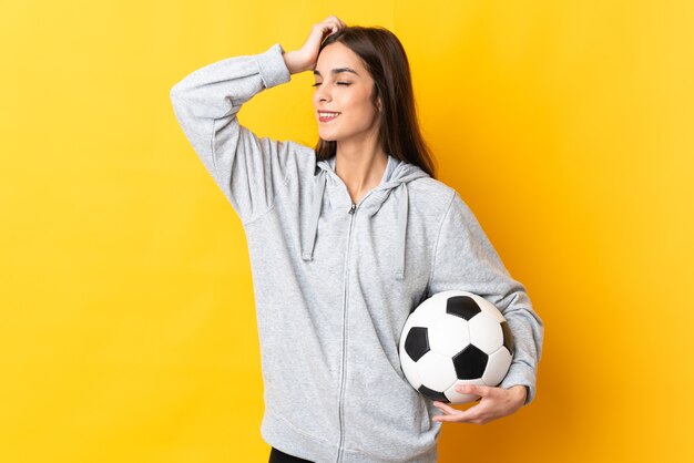 Young football player woman on yellow smiling a lot