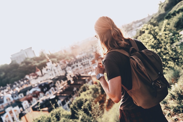 Young and free. Rear view of young man in casual clothing looking at view