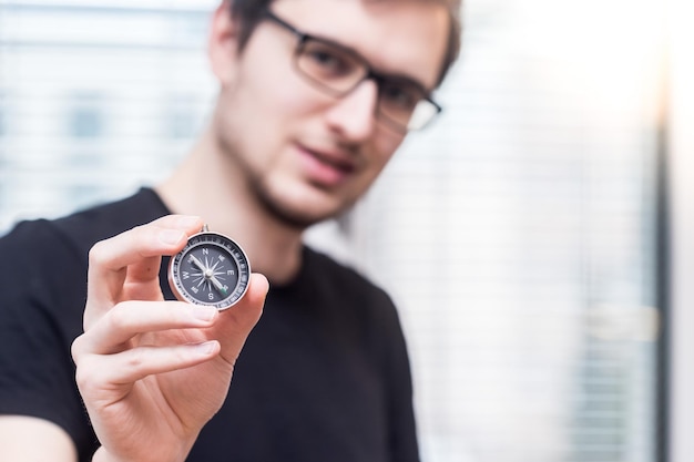 Young freelancer with compass holding in hand