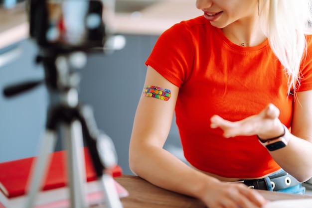 Young freelancer woman works and makes notes while working at home in quarantine lockdown