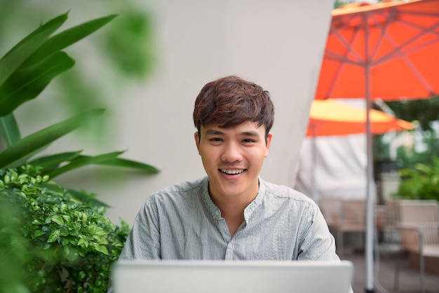 Young freelancer working on laptop in coffee