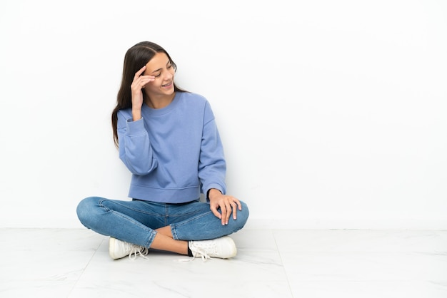 Young French girl sitting on the floor laughing