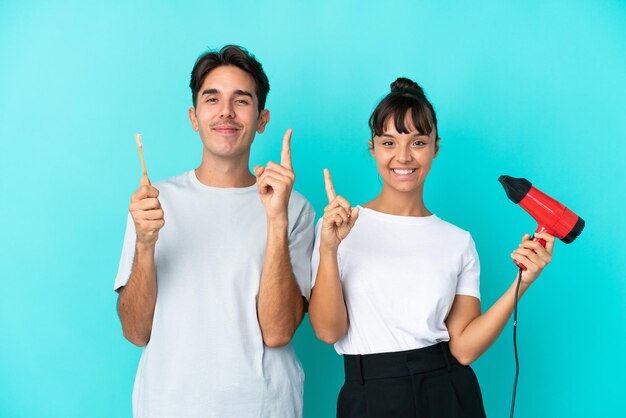 Young French woman isolated on blue background holding a placard with text Stop Covid 19 making a deal