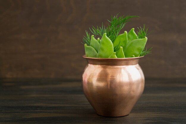 Young fresh green peas on wooden background.