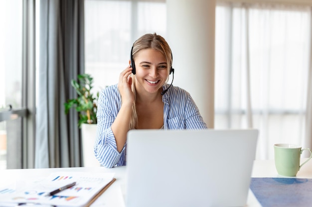 Young friendly operator woman agent with headsets Beautiful business woman wearing microphone headset working in the office as a telemarketing customer service agent call center job concept