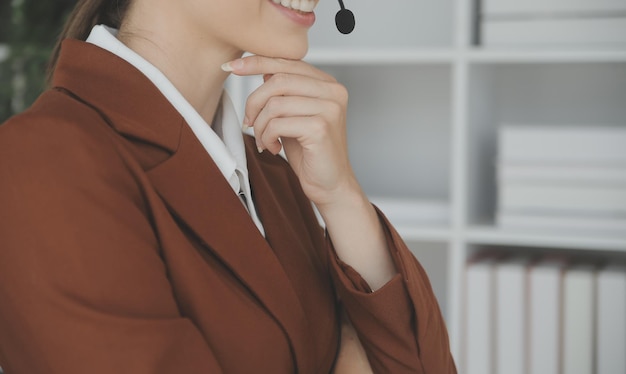 Young friendly operator woman agent with headsets working in a call centre