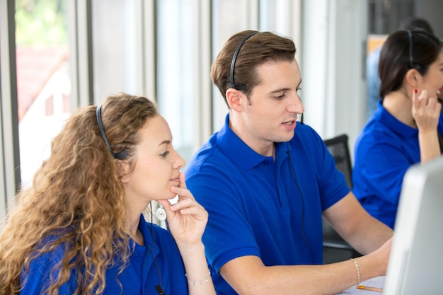 Young friendly operator woman agent with headsets working in a\
call centre