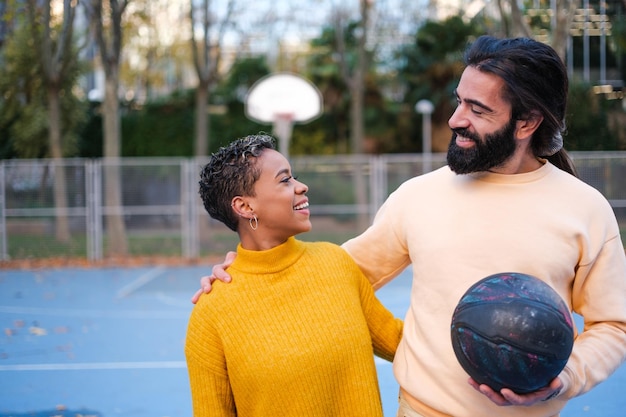 Young friends on a basketball court in a different afternoon of outdoor fun Concept sport lifestyle together