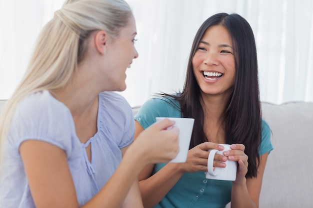 Young friends catching up over cups of coffee