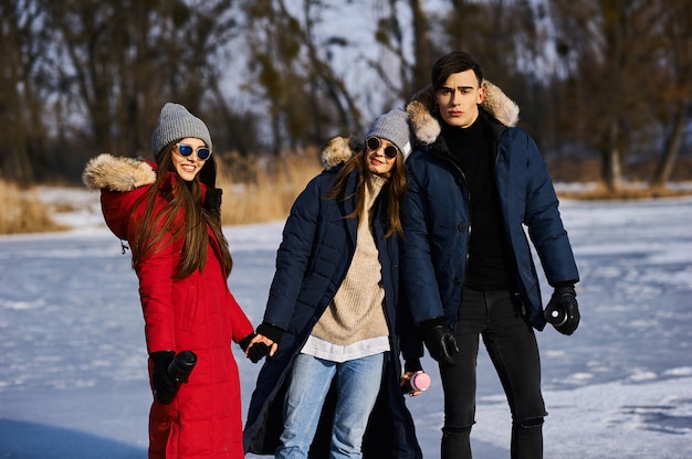 Young friends having fun outdoors in winter time