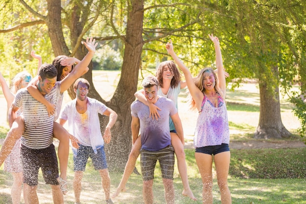 Young friends having fun with hose in the park