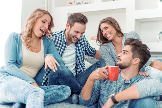 Young friends having a great time in living room