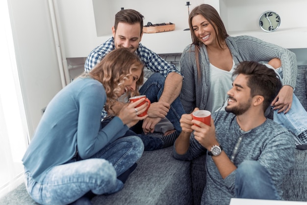 Young friends having a great time in living room