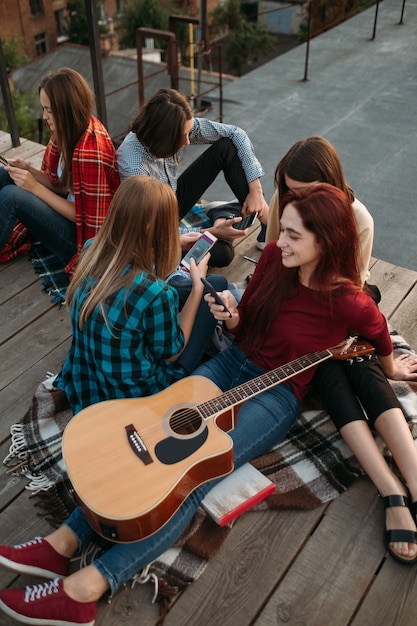 Giovani amici che guardano i loro smartphone. dipendenza dai social. problemi dell'adolescenza moderna. bisogno di condivisione