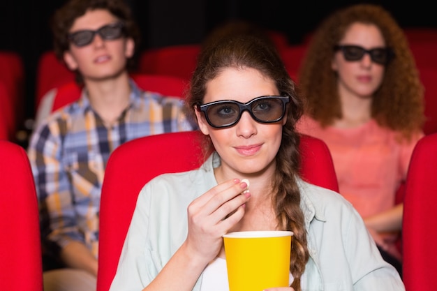 Photo young friends watching a 3d film