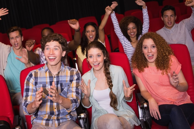 Young friends watching a film