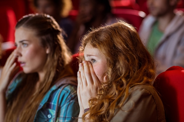 Young friends watching a film