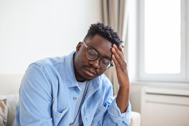 young frustrated man suffering from chronic daily headaches treatment online appointing to a medical consultation electromagnetic radiation sick pay