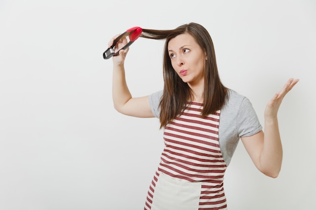 Young fun attractive smiling brunette caucasian housewife in striped apron isolated