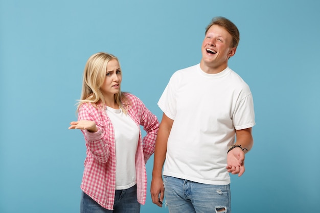 Young fun couple two friends guy girl in white pink empty blank design t-shirts posing 