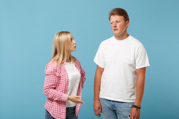 Young fun couple two friends guy girl in white pink empty blank design t-shirts posing 